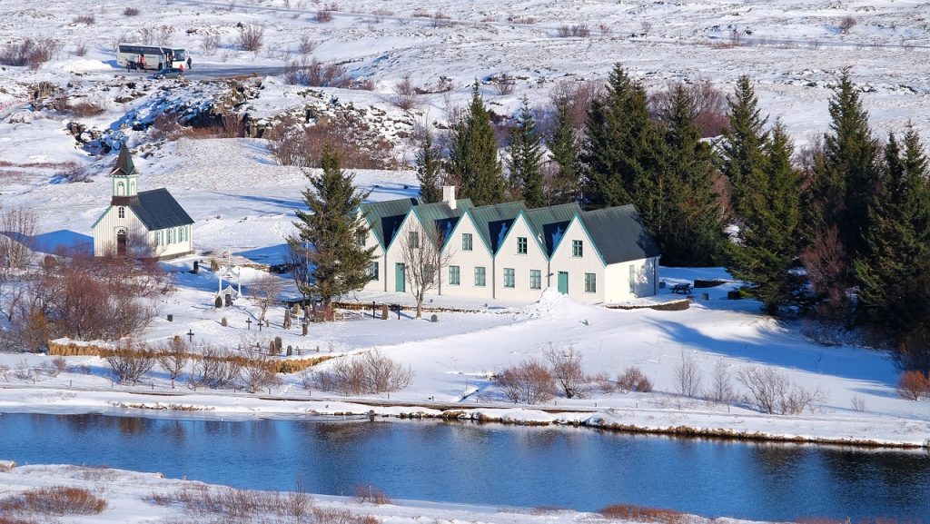 a large white house with a pool in front of it