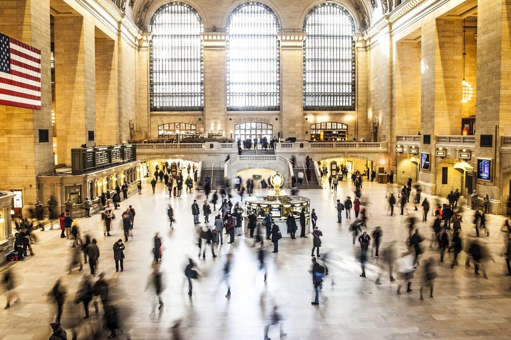 a large group of people in a large building with Grand Central Terminal in the background