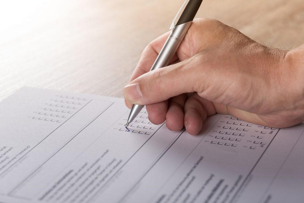 a person writing on a piece of paper