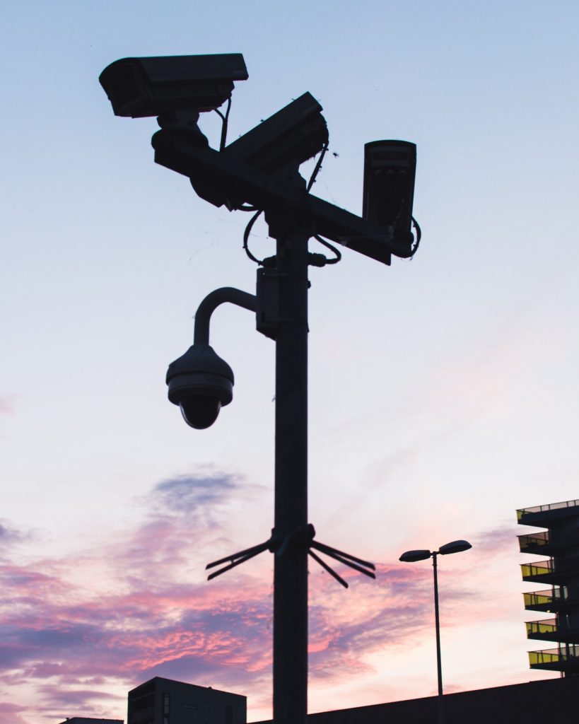 a street light with a purple and pink sky in the background