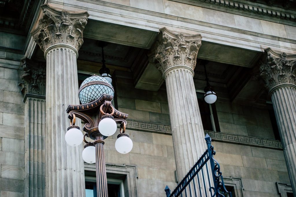 a statue of a person holding a torch in front of a building