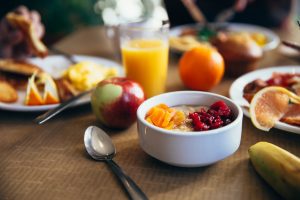 a bowl of fruit next to a bowl of cereal