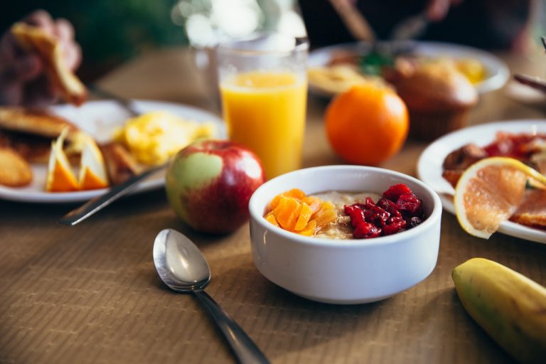 a bowl of fruit next to a bowl of cereal