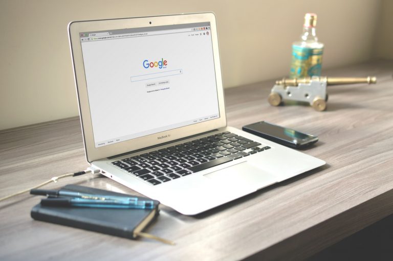 a laptop and cell phone on a table