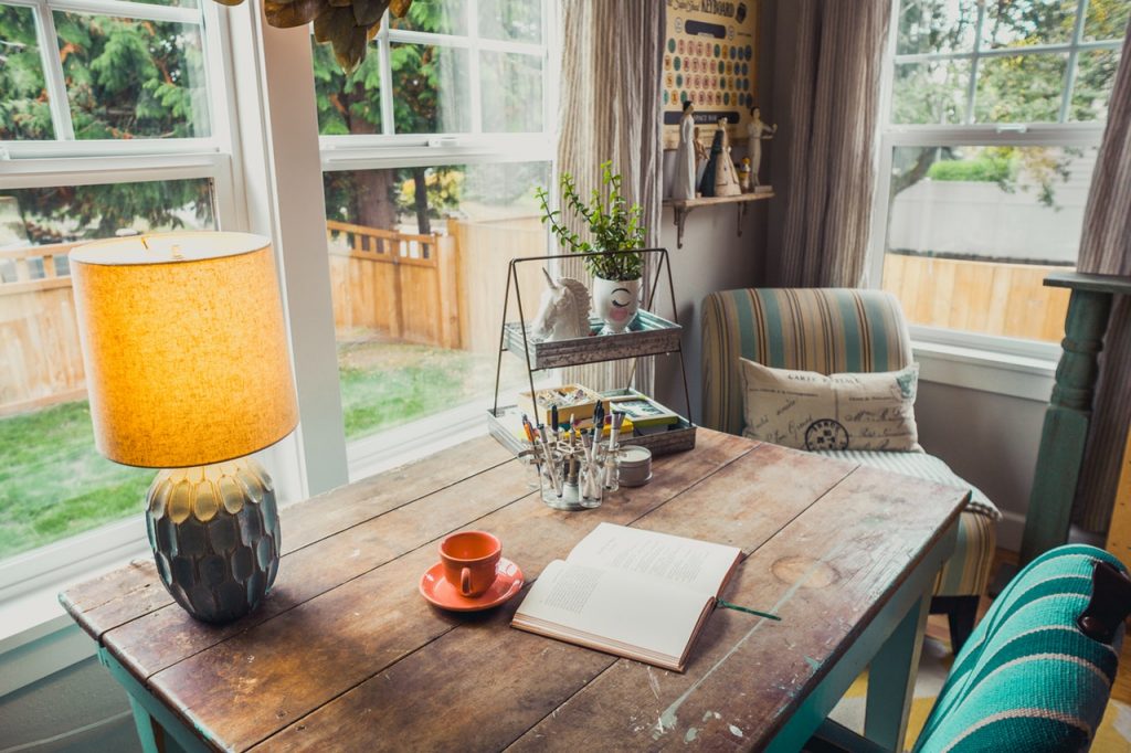 a table with a lamp and a book on it