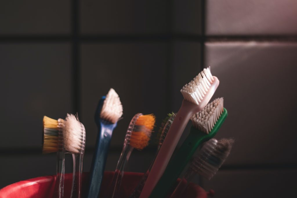 toothbrushes and toothpaste in a bathroom