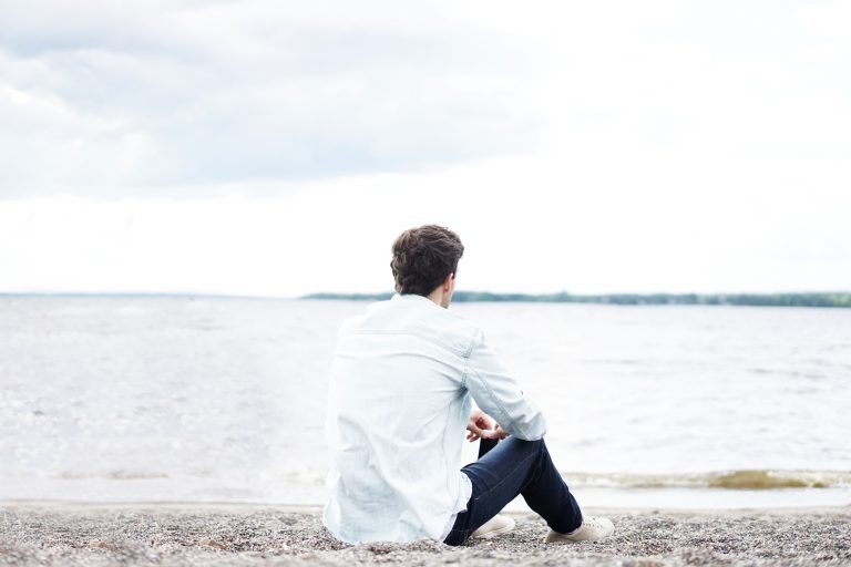 a man sitting on a beach