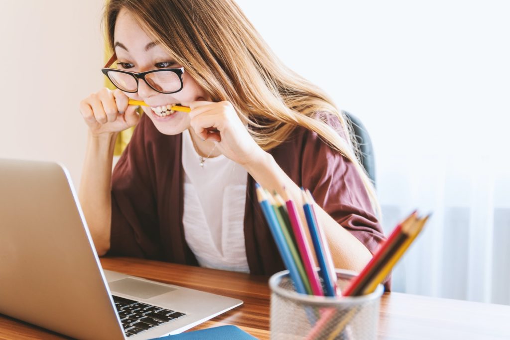 a person with glasses and a pencil