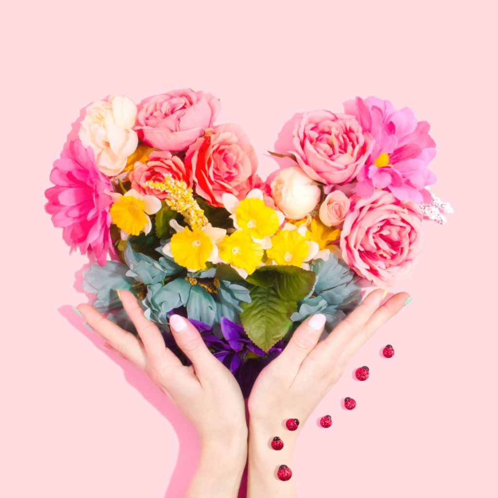 a hand holding a bouquet of flowers