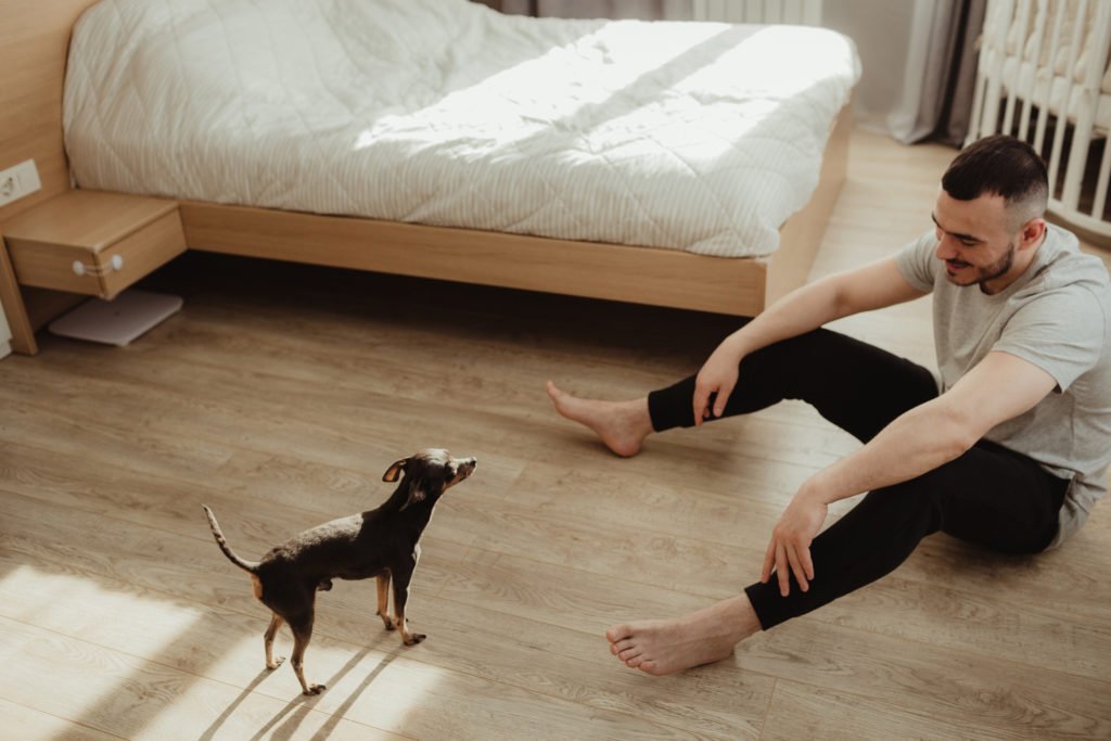 a person and a dog sitting on the floor