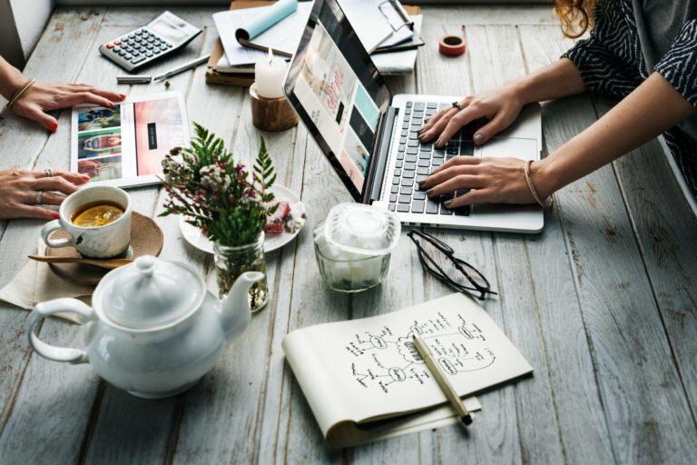 a table with a laptop and coffee