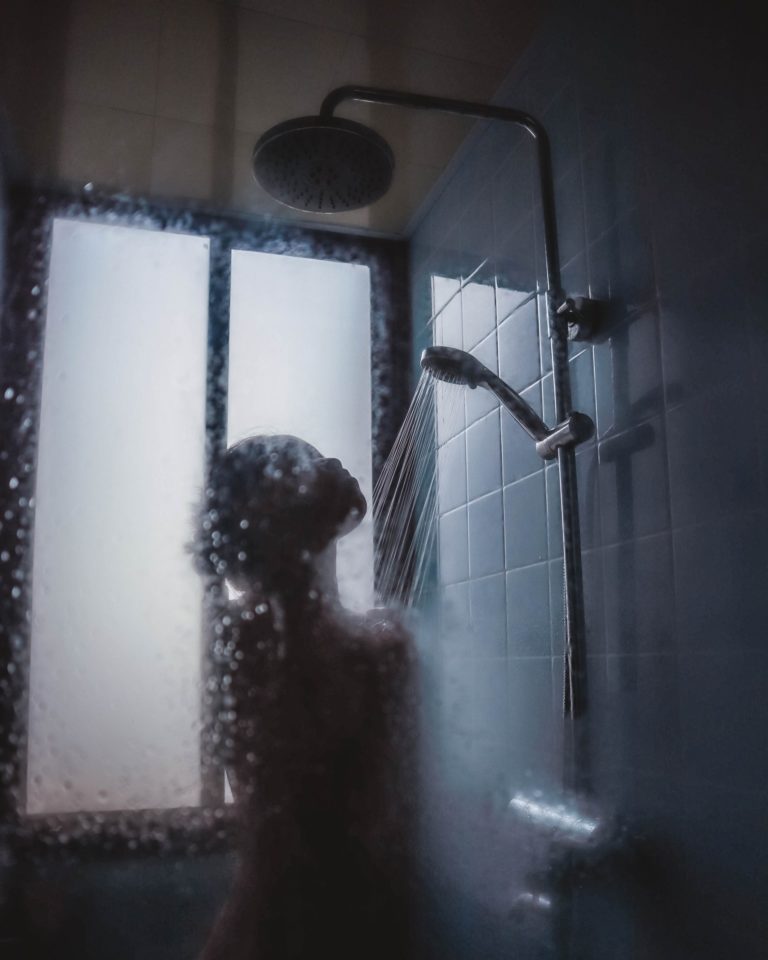 a dog looking at a shower