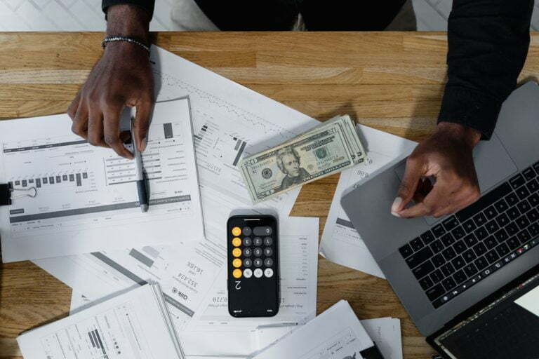 a person working on a calculator and calculator