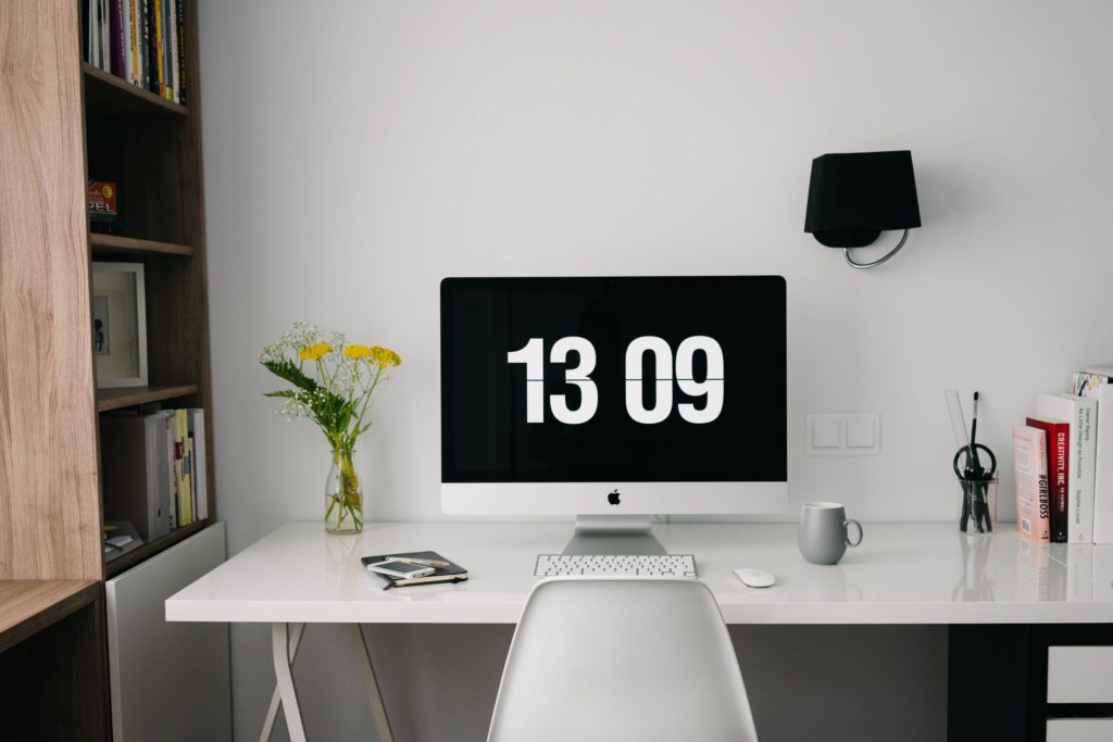 a desk with a computer and a chair