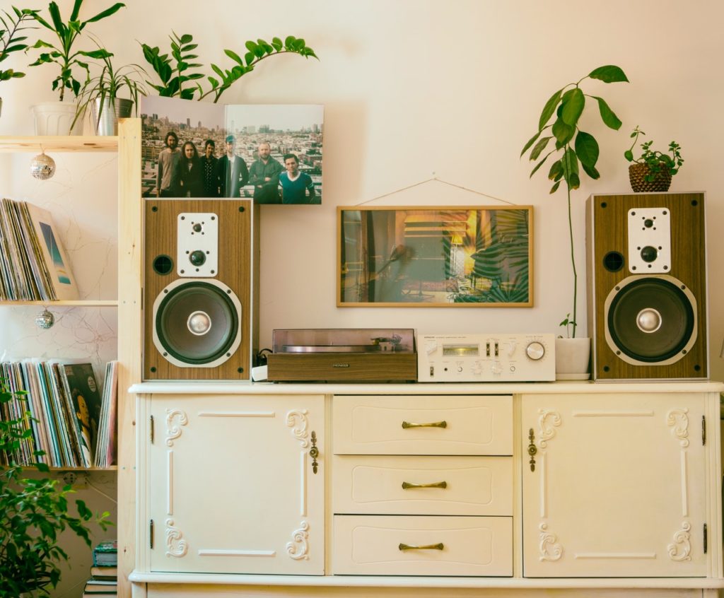 a white dresser with a camera on top of it