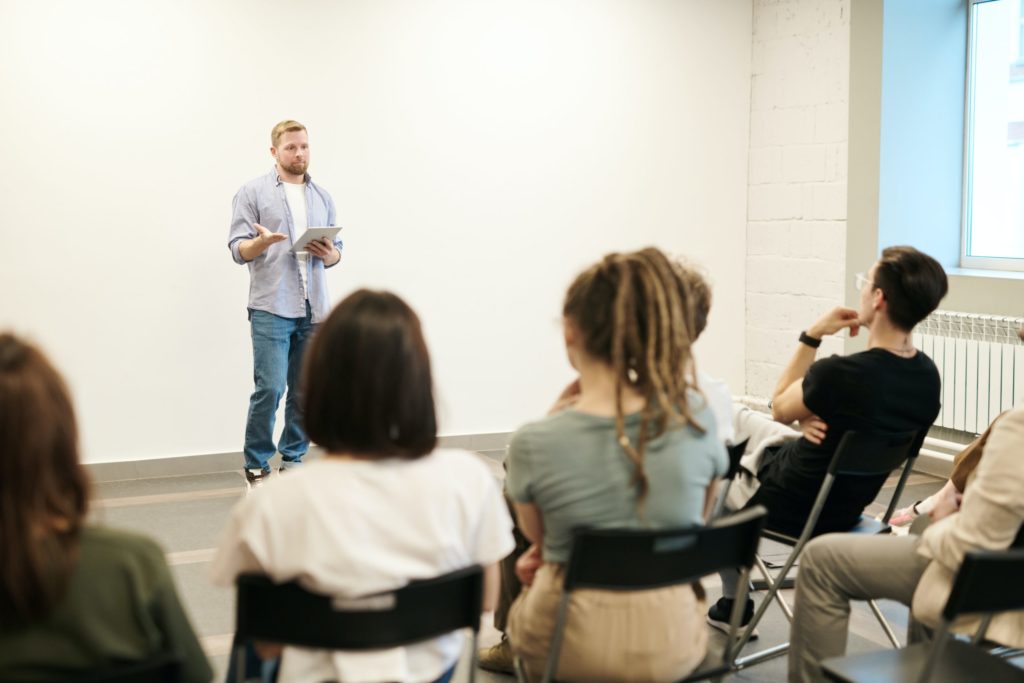 a woman speaking to a group of people