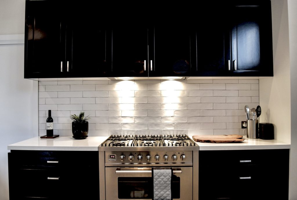 a kitchen with black cabinets