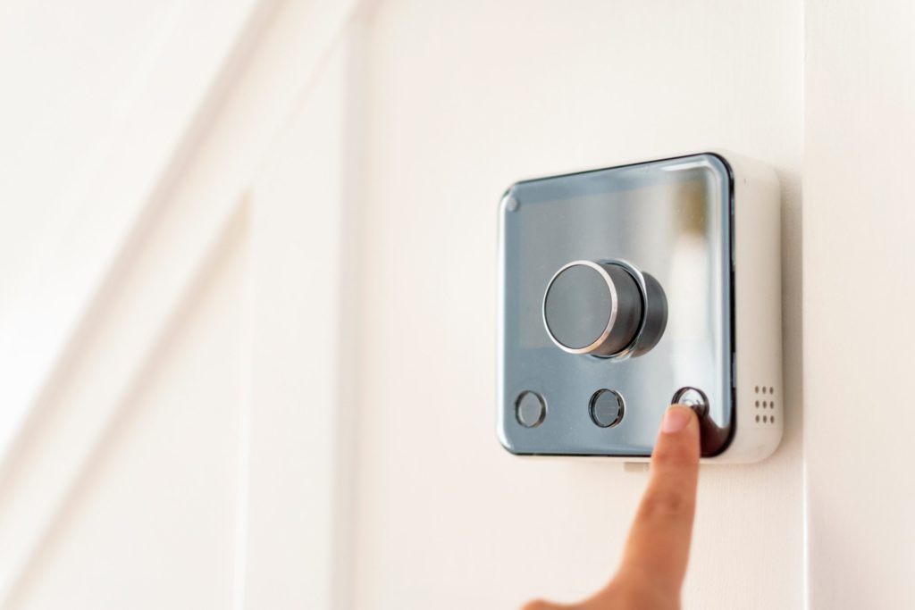 a hand holding a silver camera