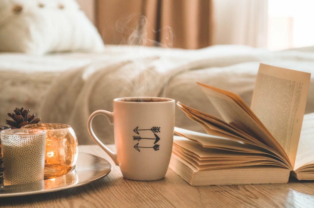 a book and a cup of coffee on a table