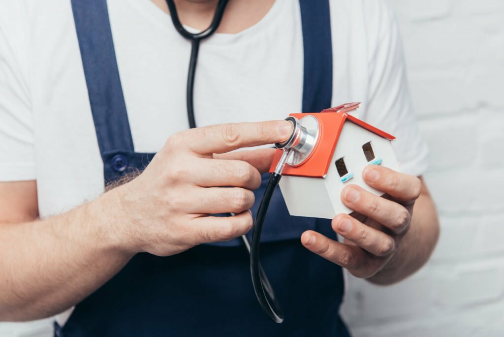 a few hands holding a small red and white object