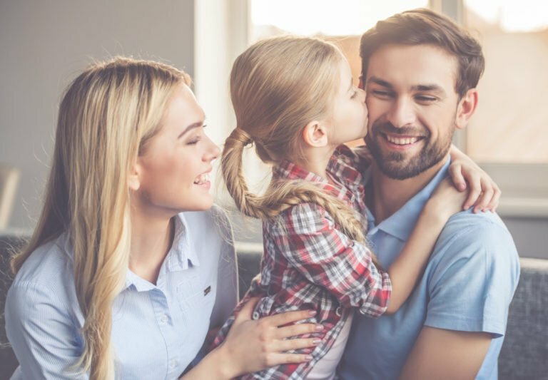 a family smiling and hugging