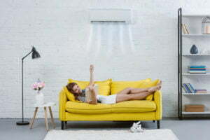 a person lying on a yellow couch