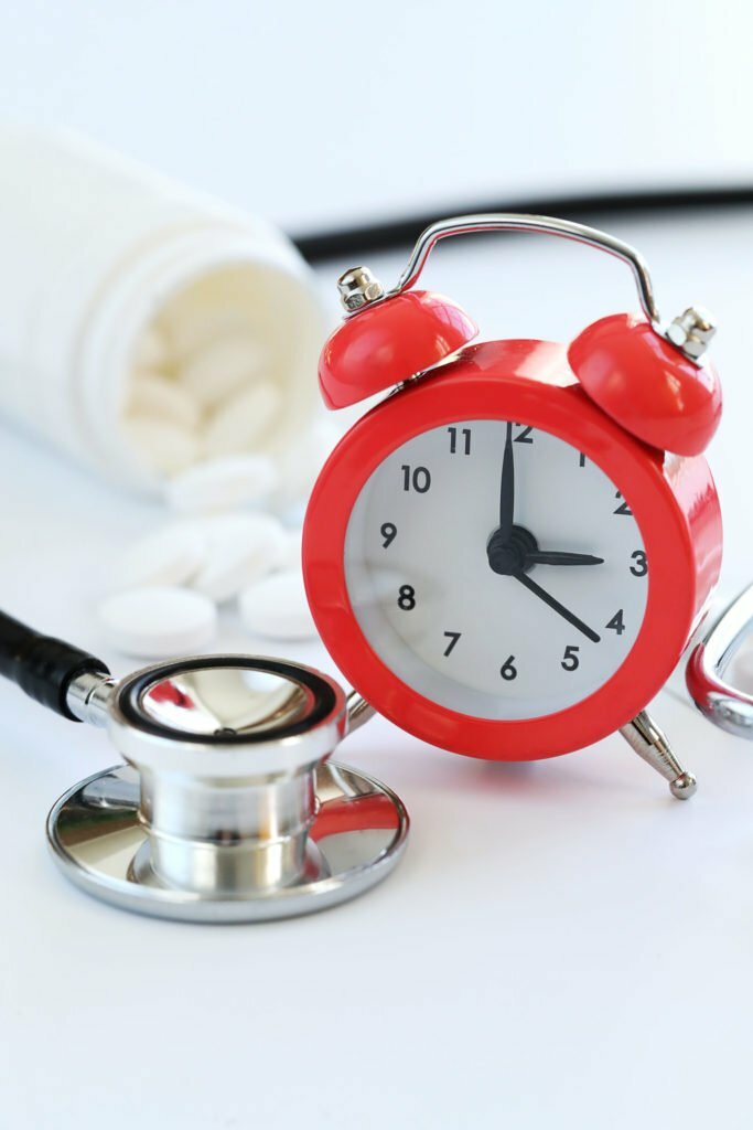 red clock with medical tools