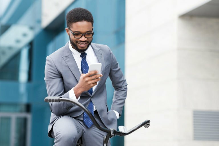 man on a cell phone while on a bike