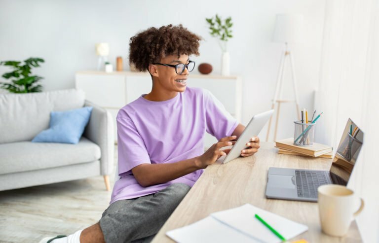 a person sitting at a table working on a laptop