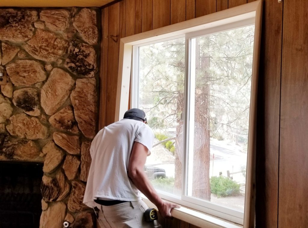 WORKER INSTALLING A WINDOW