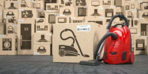 Vacuum cleaner in warehouse with household appliances and kitchen electronics in boxes. Online purchase, shopping and delivery concept. 3d illustration
