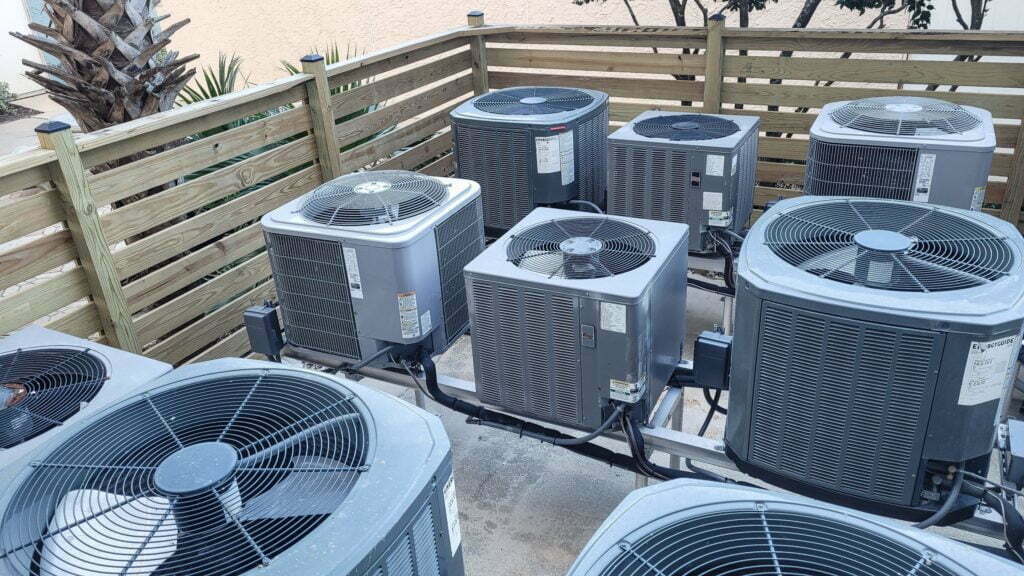 Air conditioners raised platforms at beach serviced by HVAC technicians .