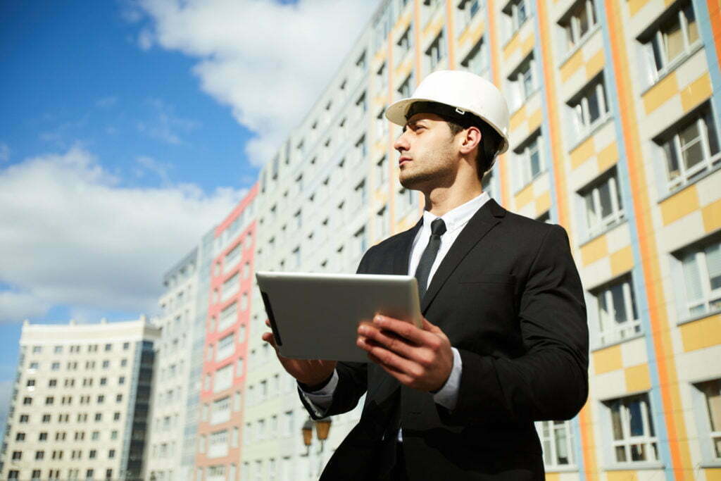 Businessman by Apartment Building