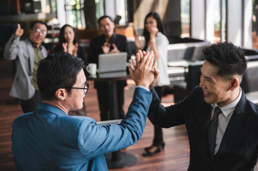 Group of sucessful business person and coworker hand shaking with smile and happy