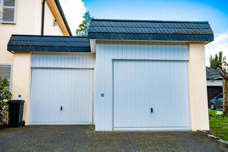 wide garage door and concrete driveway in front