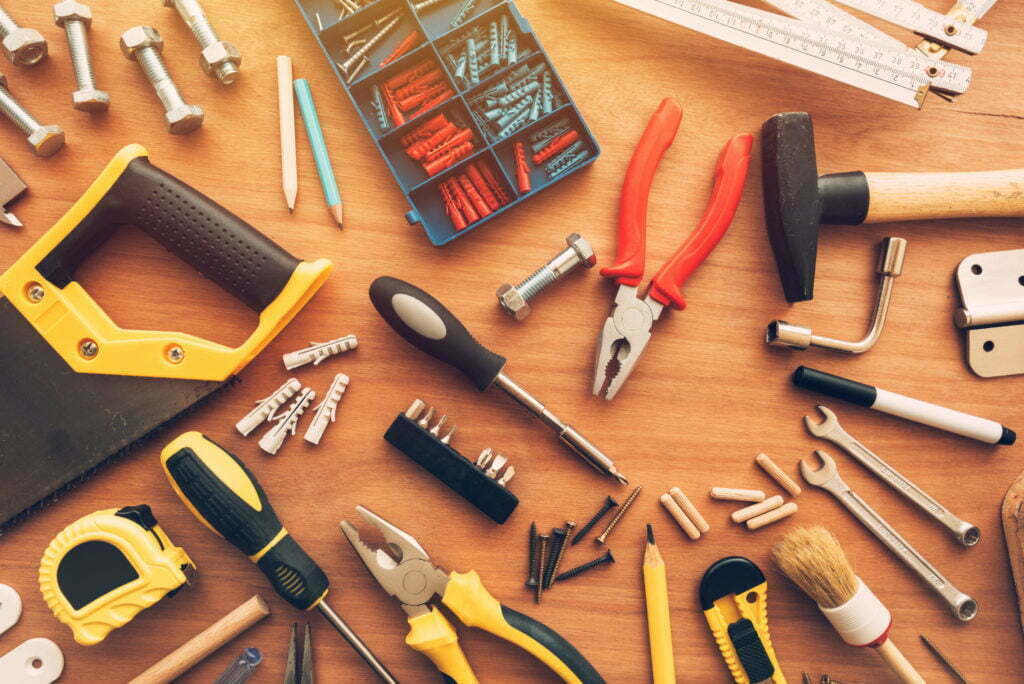 Assorted house renovation tools top view on workshop desk